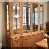 F25. American Drew lighted breakfront china cabinet with mirrored back. 88.5”h x 75”w x 20”d